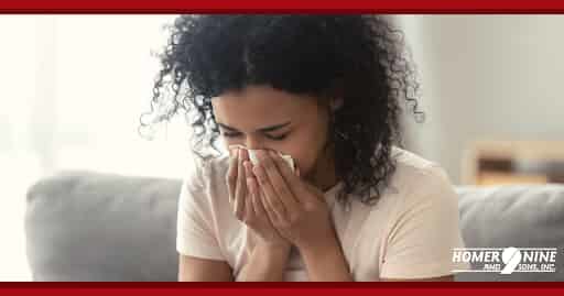 Woman sneezing inside